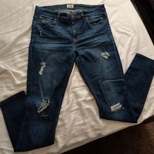 Mid rise distressed skinny jeans.